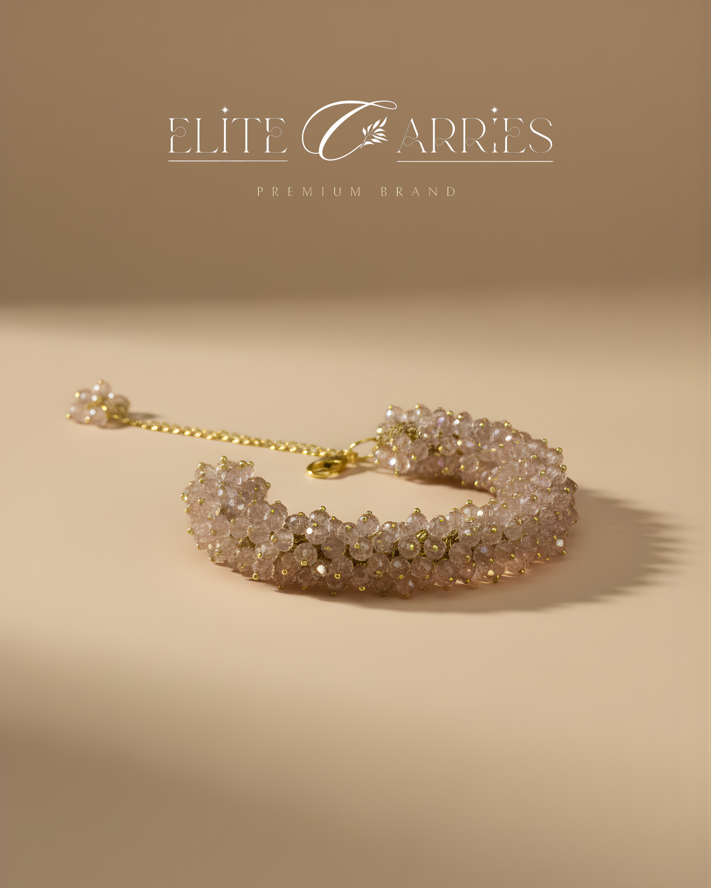 Gold bracelet on a beige background with 'Elite Carries' branding.