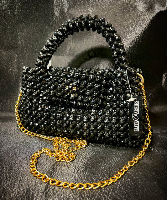 A vibrant black handbag with shimmering details, crafted for a sophisticated and glamorous look.