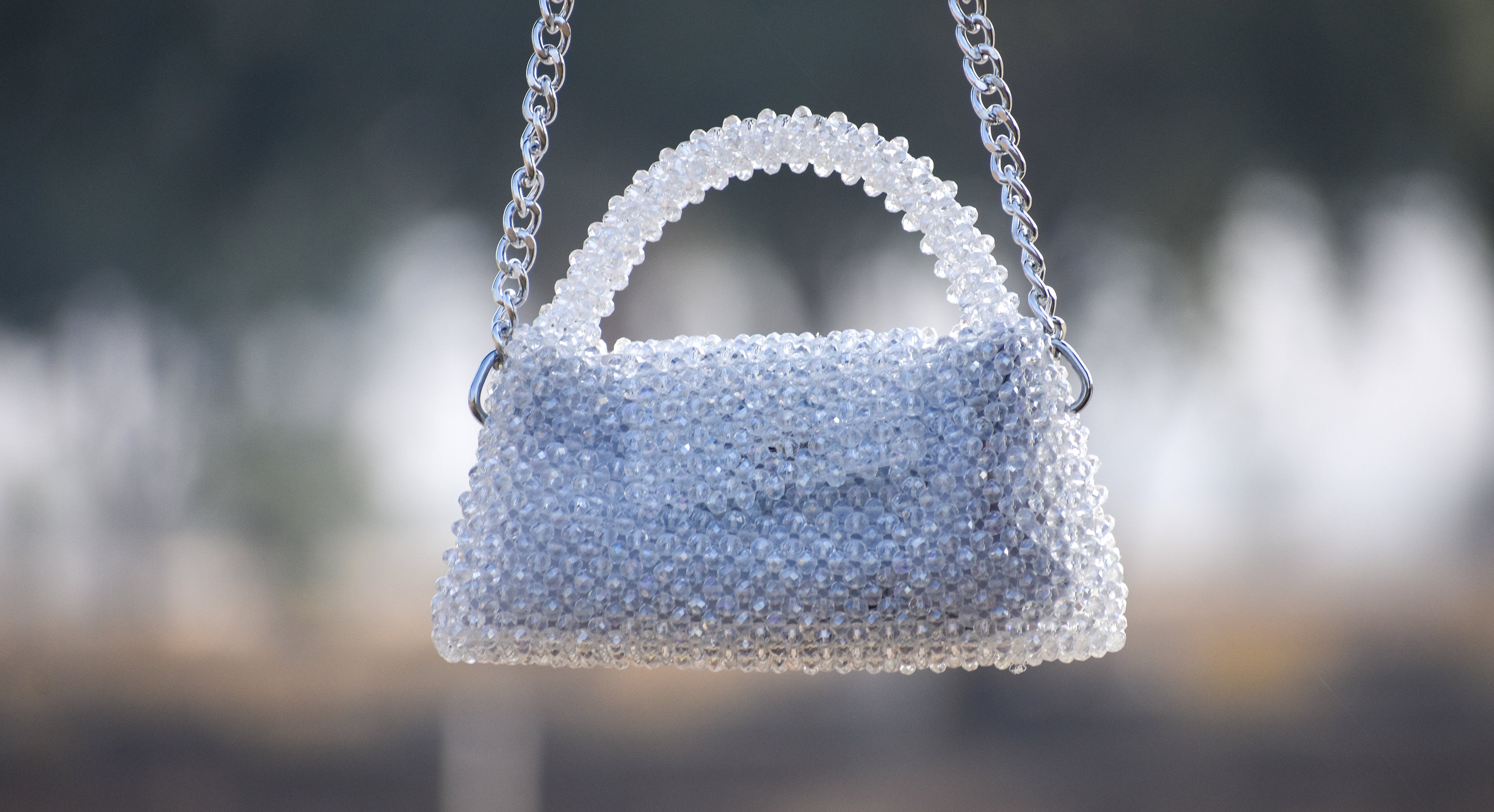 Handbag made of white beads with a blurred background