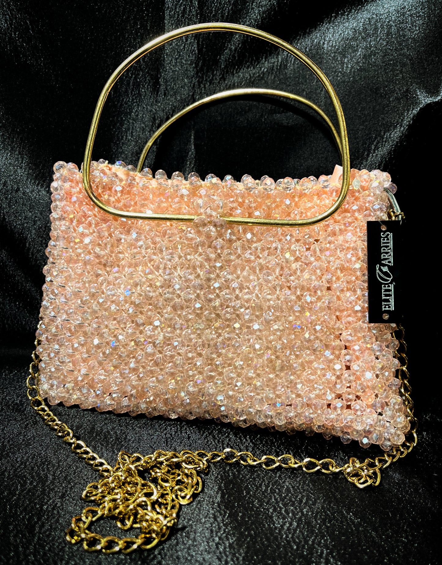 A handcrafted light peach crystal tote bag, shimmering with elegance and perfect for formal wear