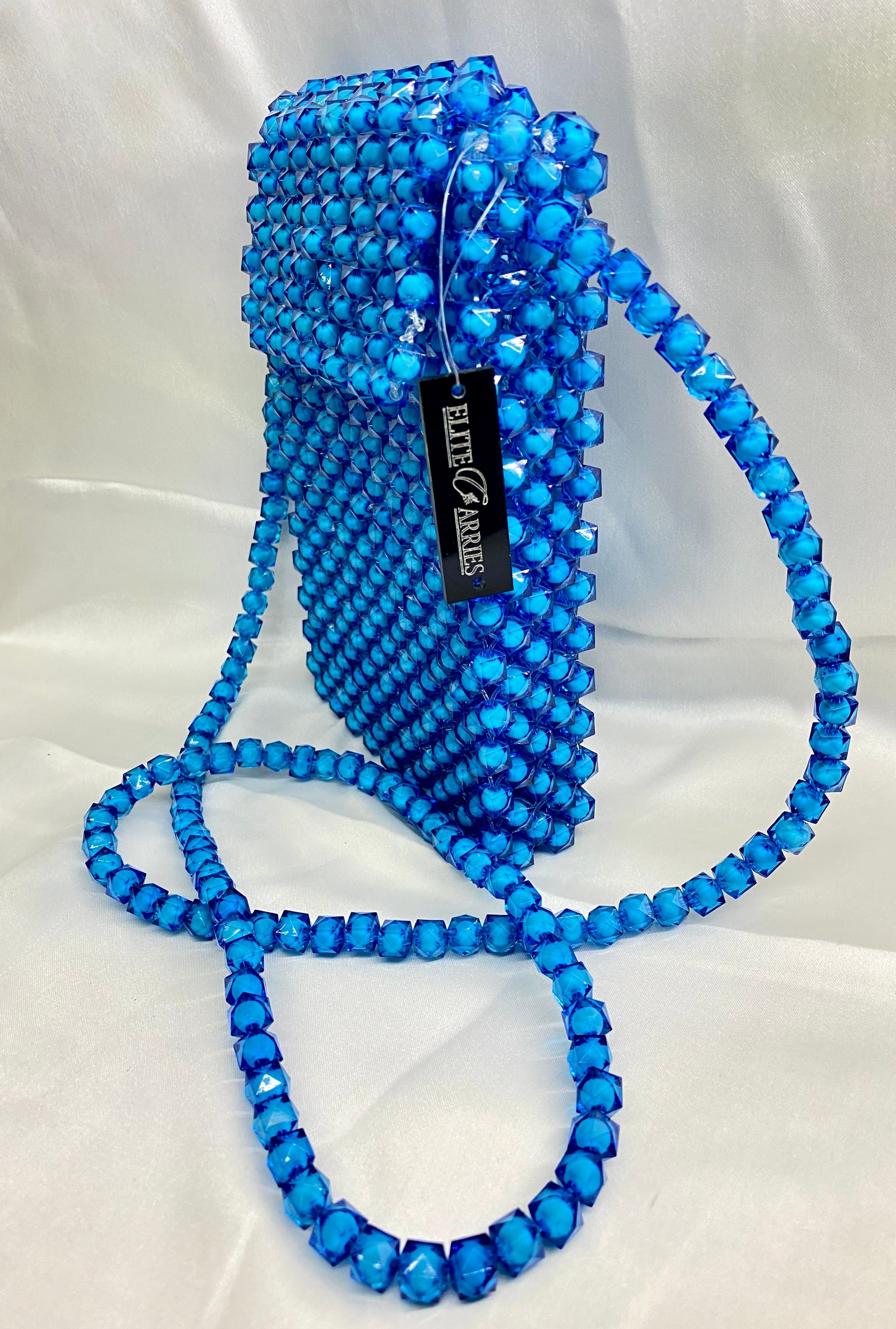 Blue beaded handbag with a long strap on a white background