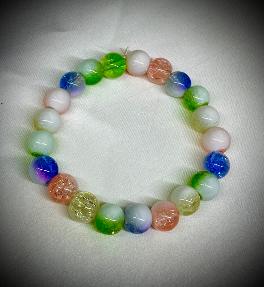 Multicolored beaded bracelet on a white fabric background