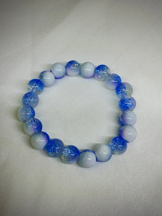 Blue and white beaded bracelet on a light gray background