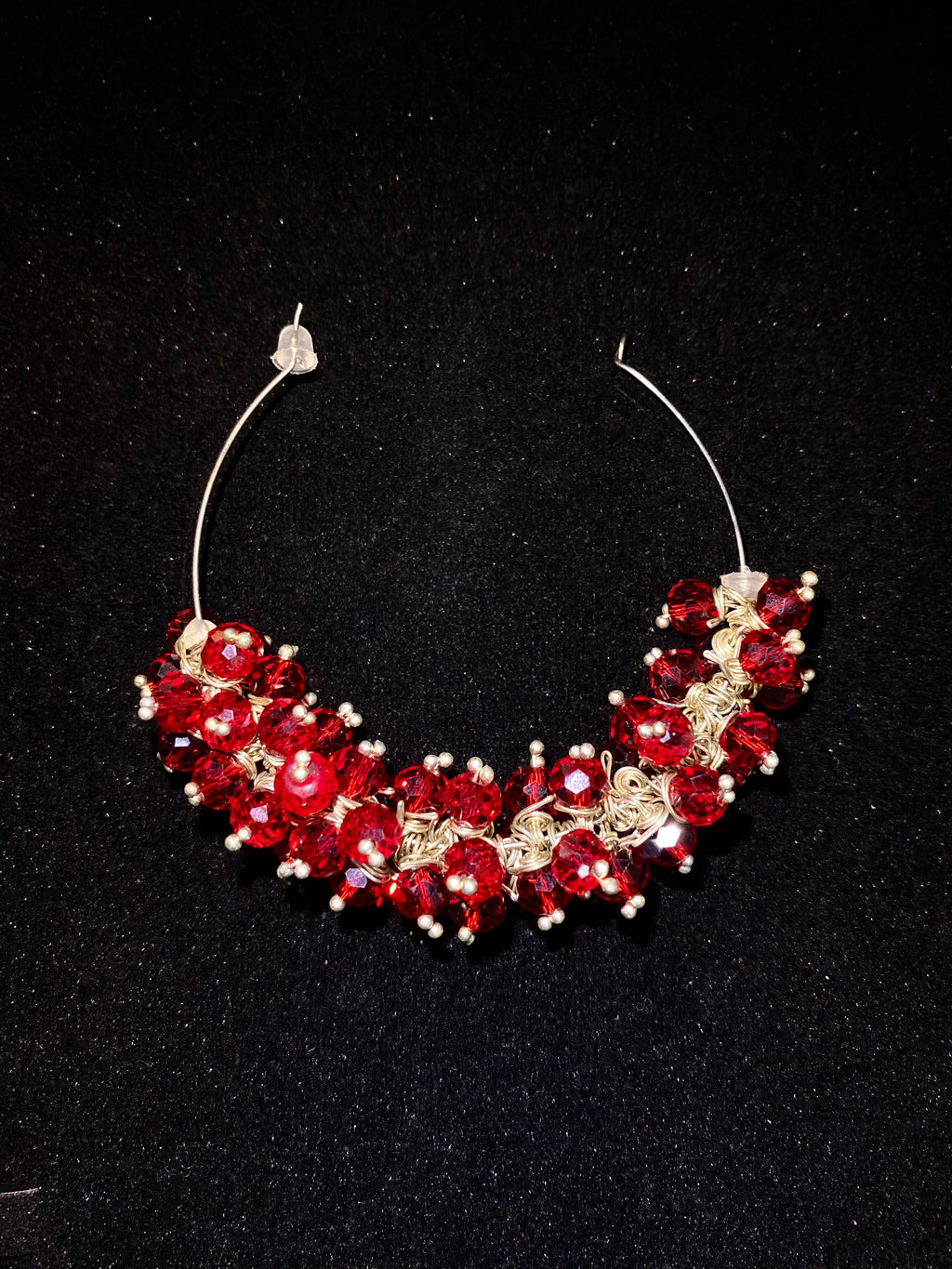 Red and gold beaded necklace on a black background