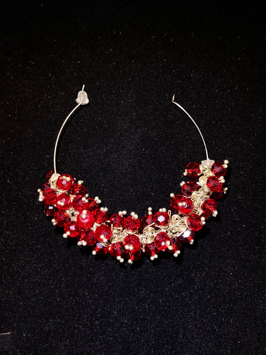 Red and gold beaded necklace on a black background