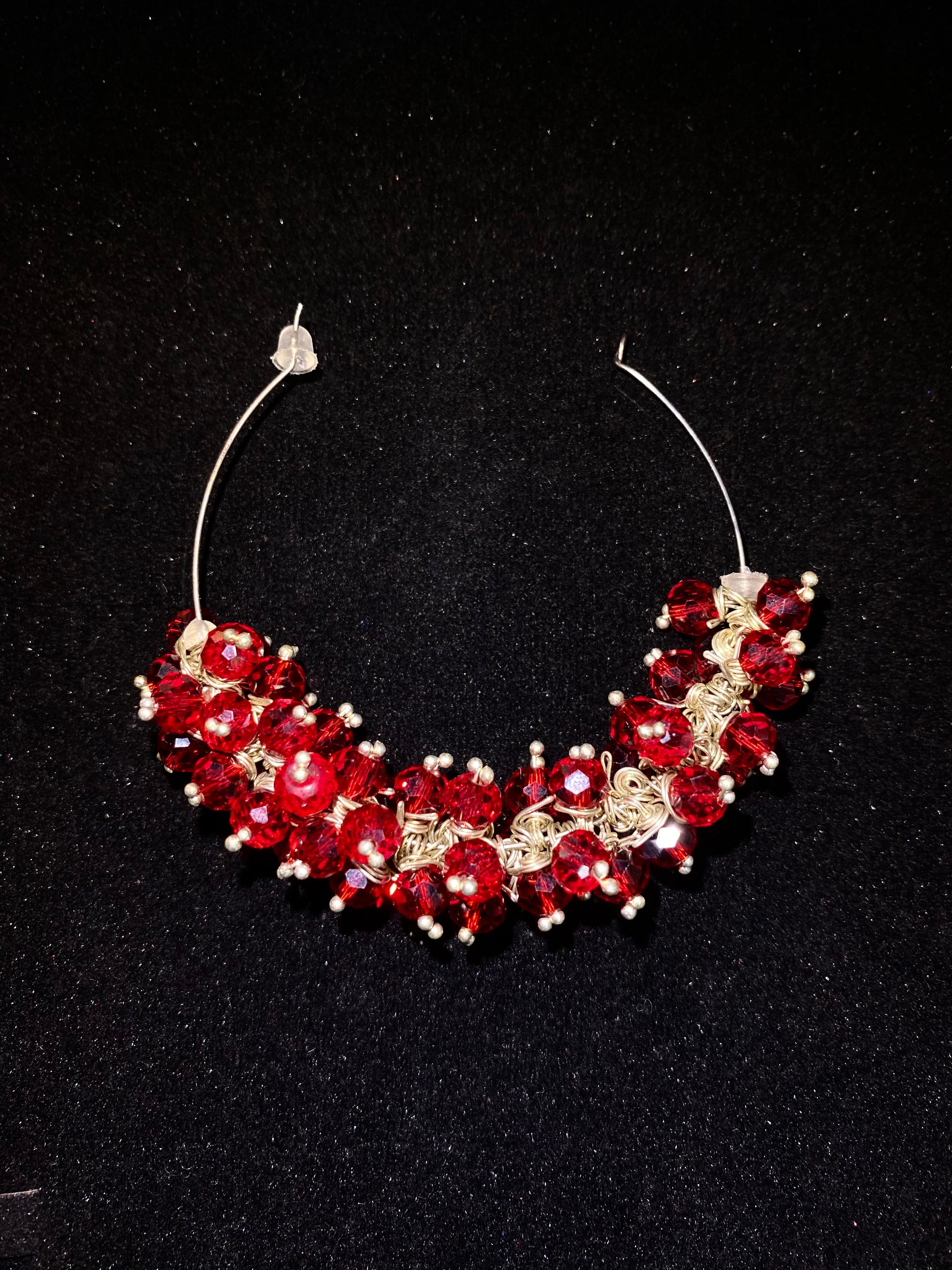 Red and gold beaded necklace on a black background