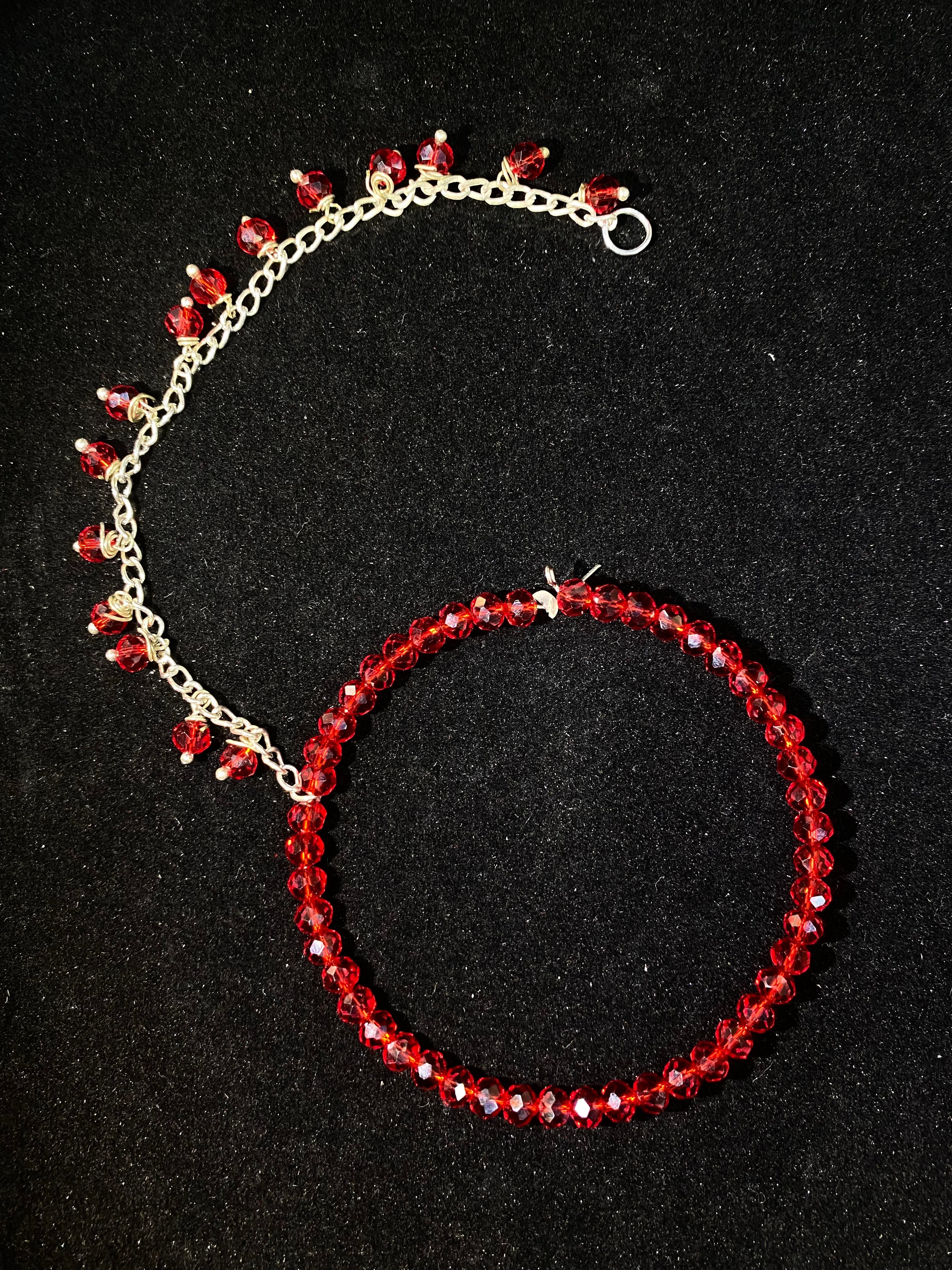Red beaded bracelet on a black background