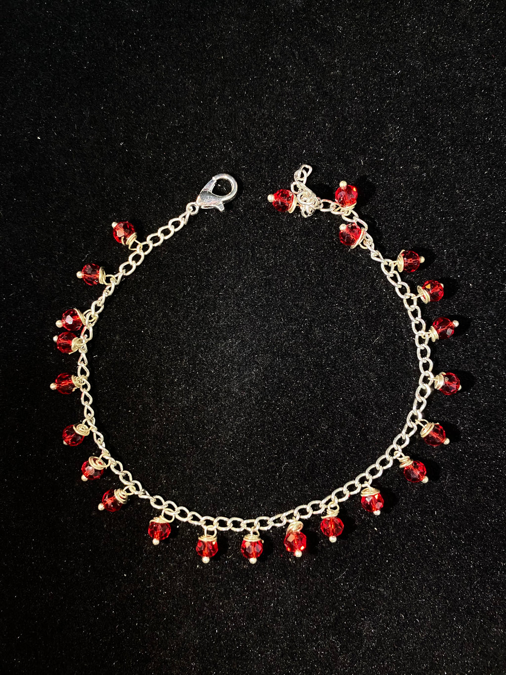 Bracelet with red beads on a black background