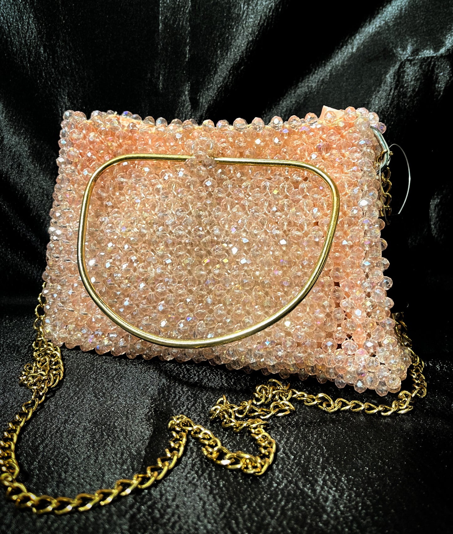 A luxury handmade crystal tote in soft peach, designed for a glamorous and sophisticated look