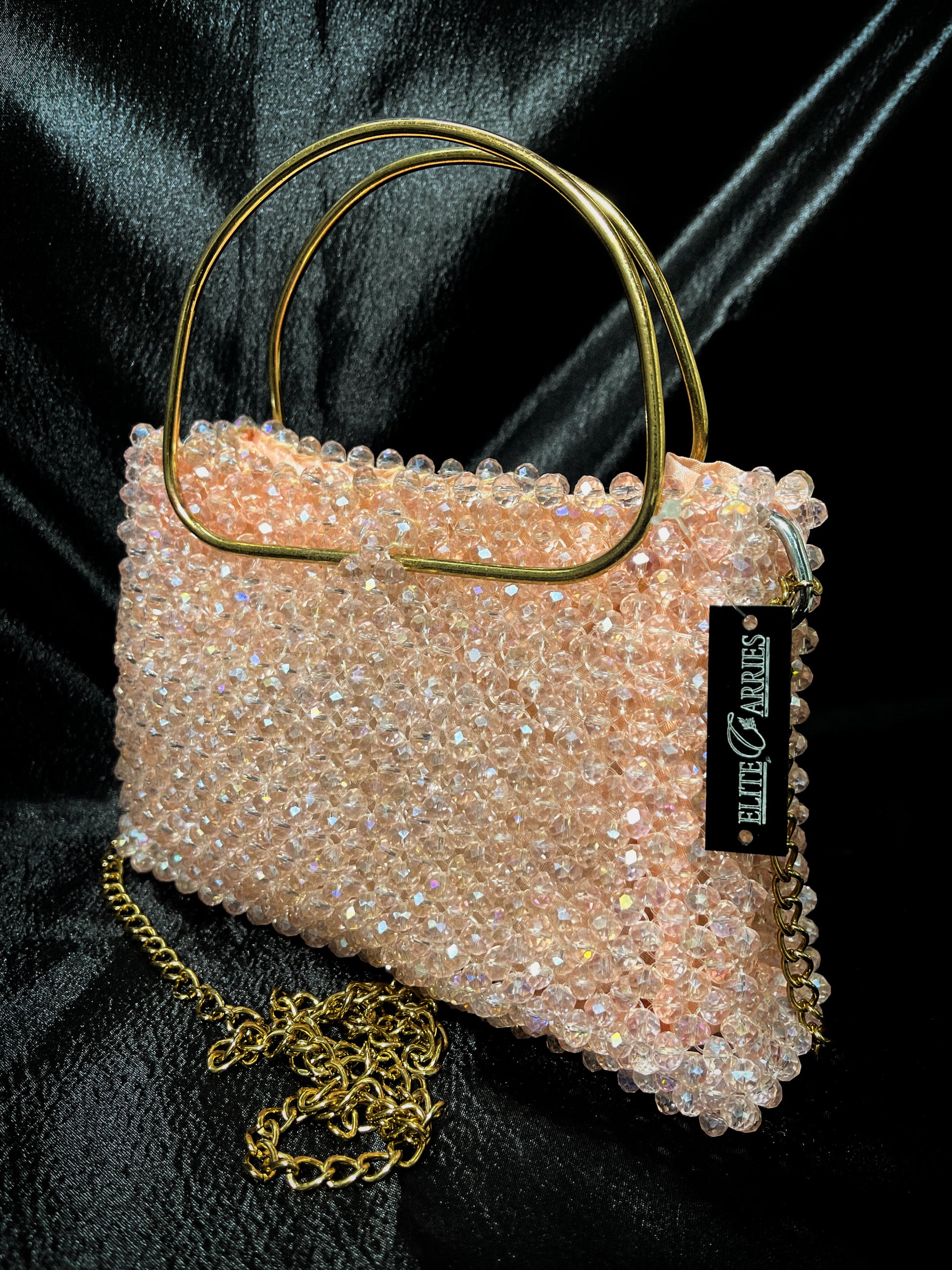 A dazzling full-handmade crystal tote in peach, ideal for weddings and evening events