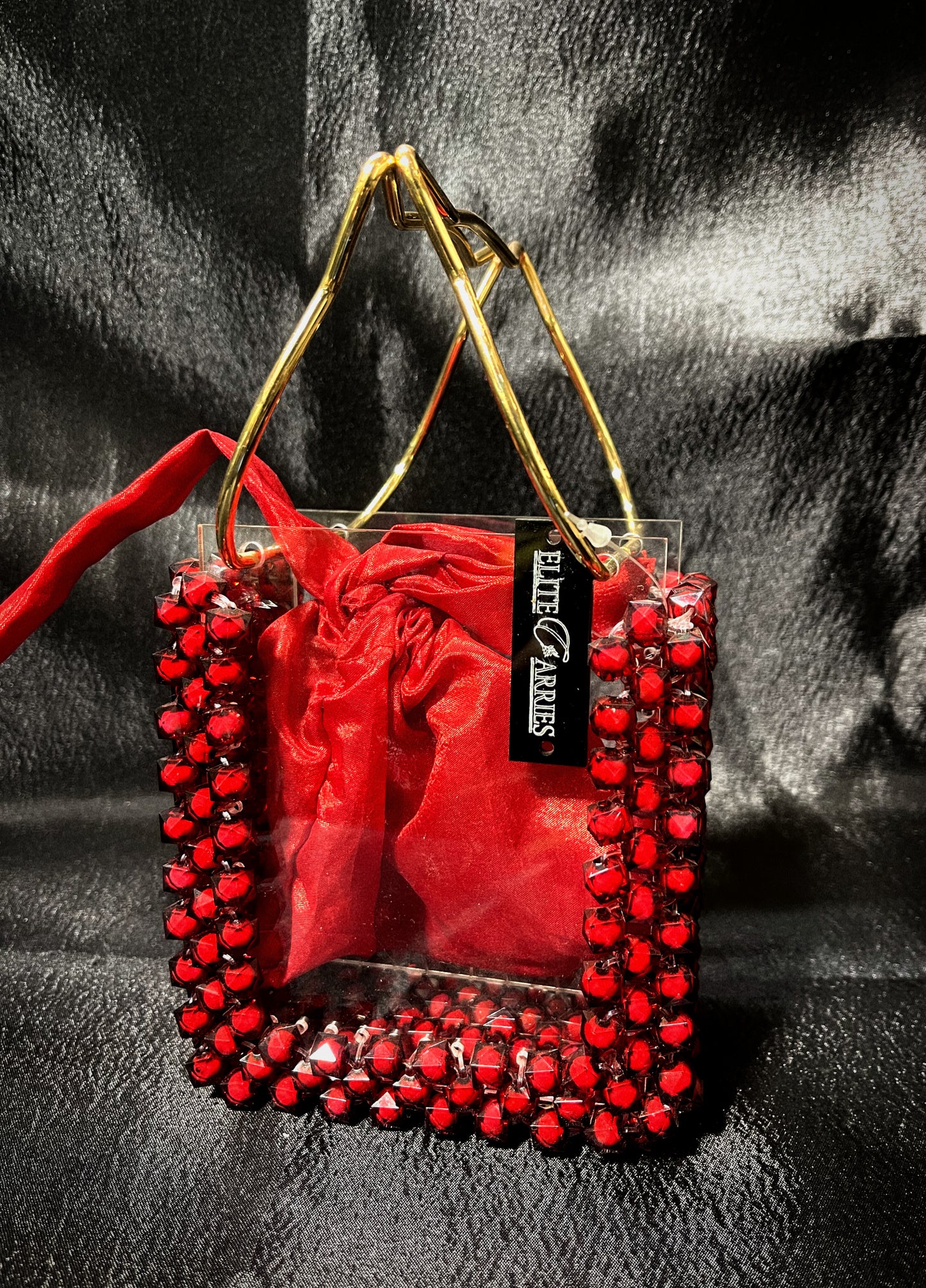 A radiant handmade red handbag, featuring a luxe glass texture for a refined look