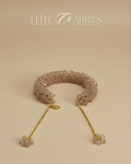 Delicate bracelet with beaded design and gold chain on a beige background, featuring the brand 'Elite Carries'.