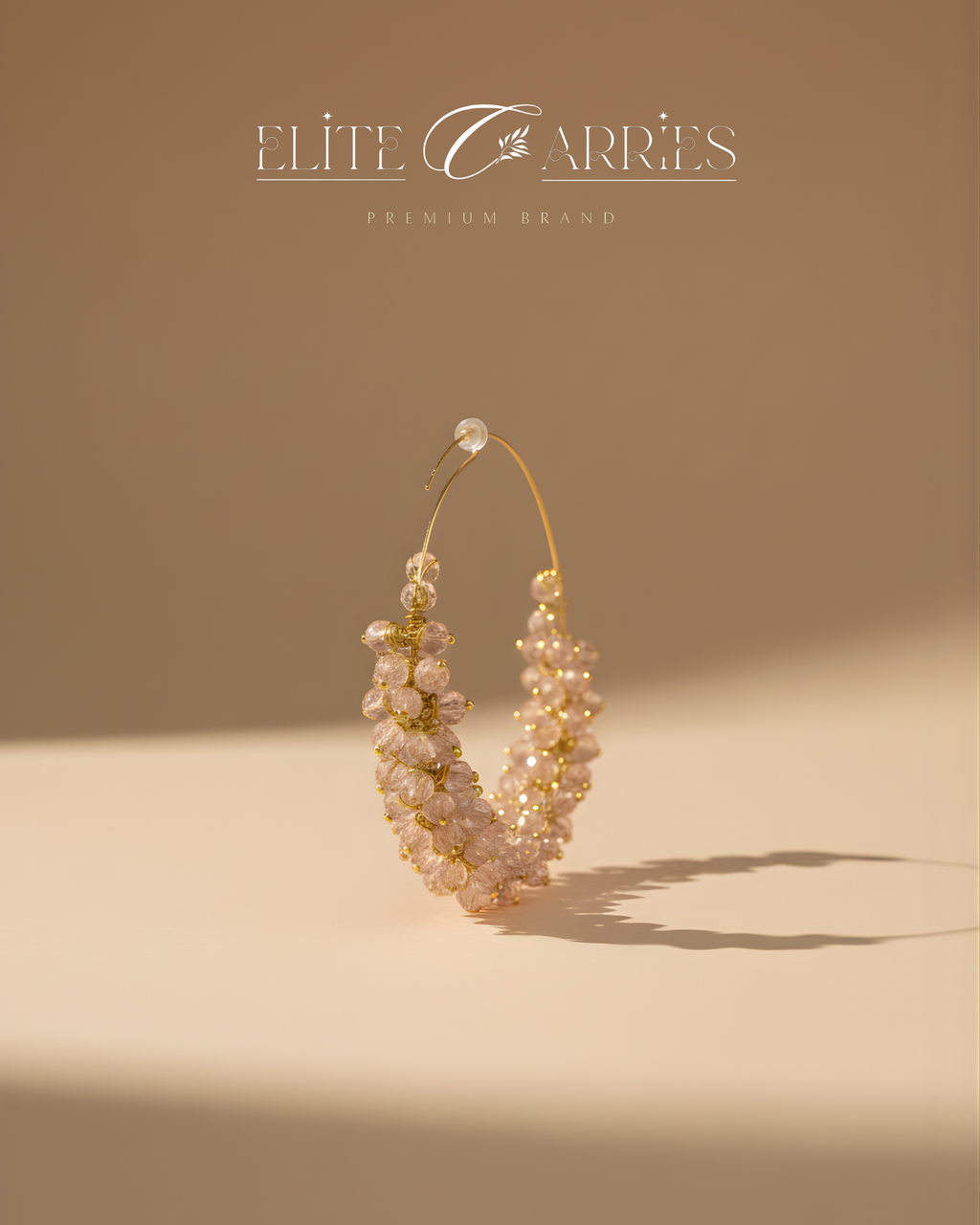 Pearl earring with gold accents on a beige background, featuring the brand 'Elite Carries'.