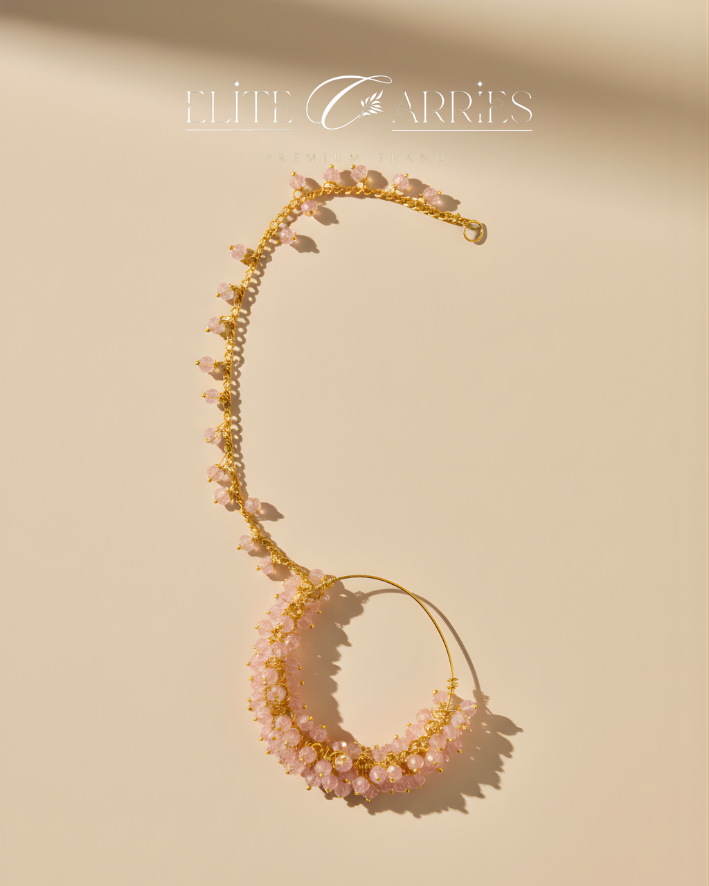 Necklace with pink stones and gold accents on a beige background, featuring the brand 'Elise Carreres'.