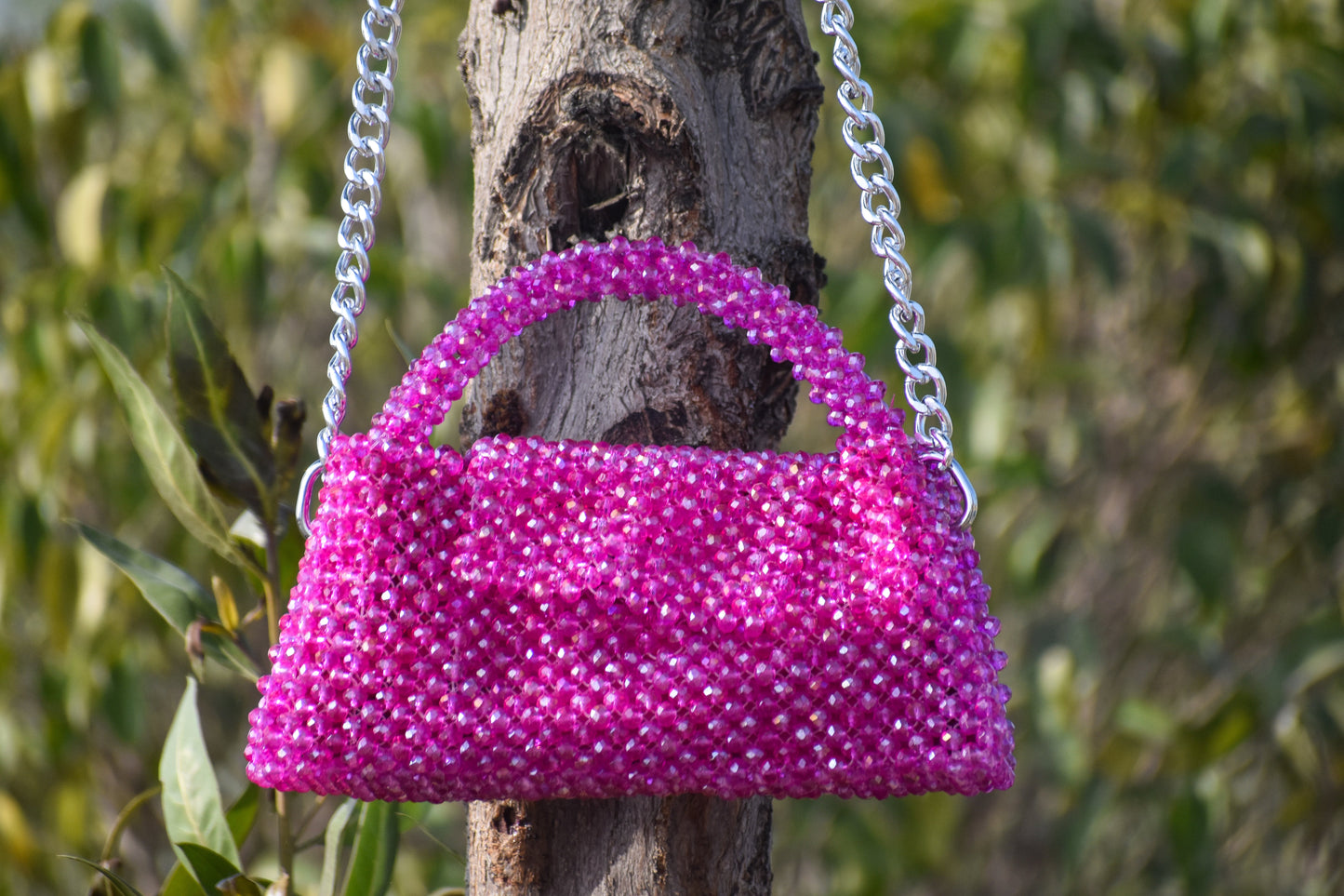 A front view of the Magenta Mystique handbag, showcasing its vibrant magenta hue and elegant design.